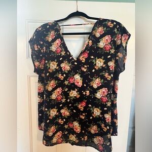 Navy sleeveless blouse with feminine floral print